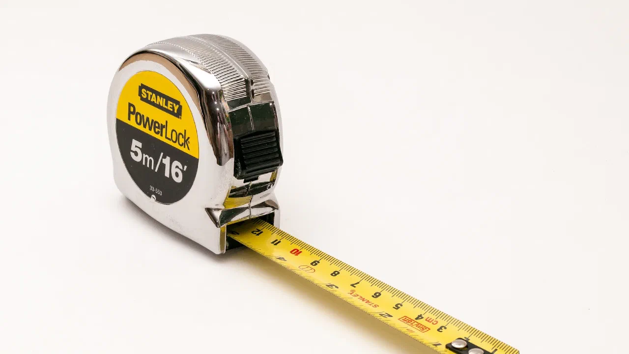 a close-up of a tape measure against a white background